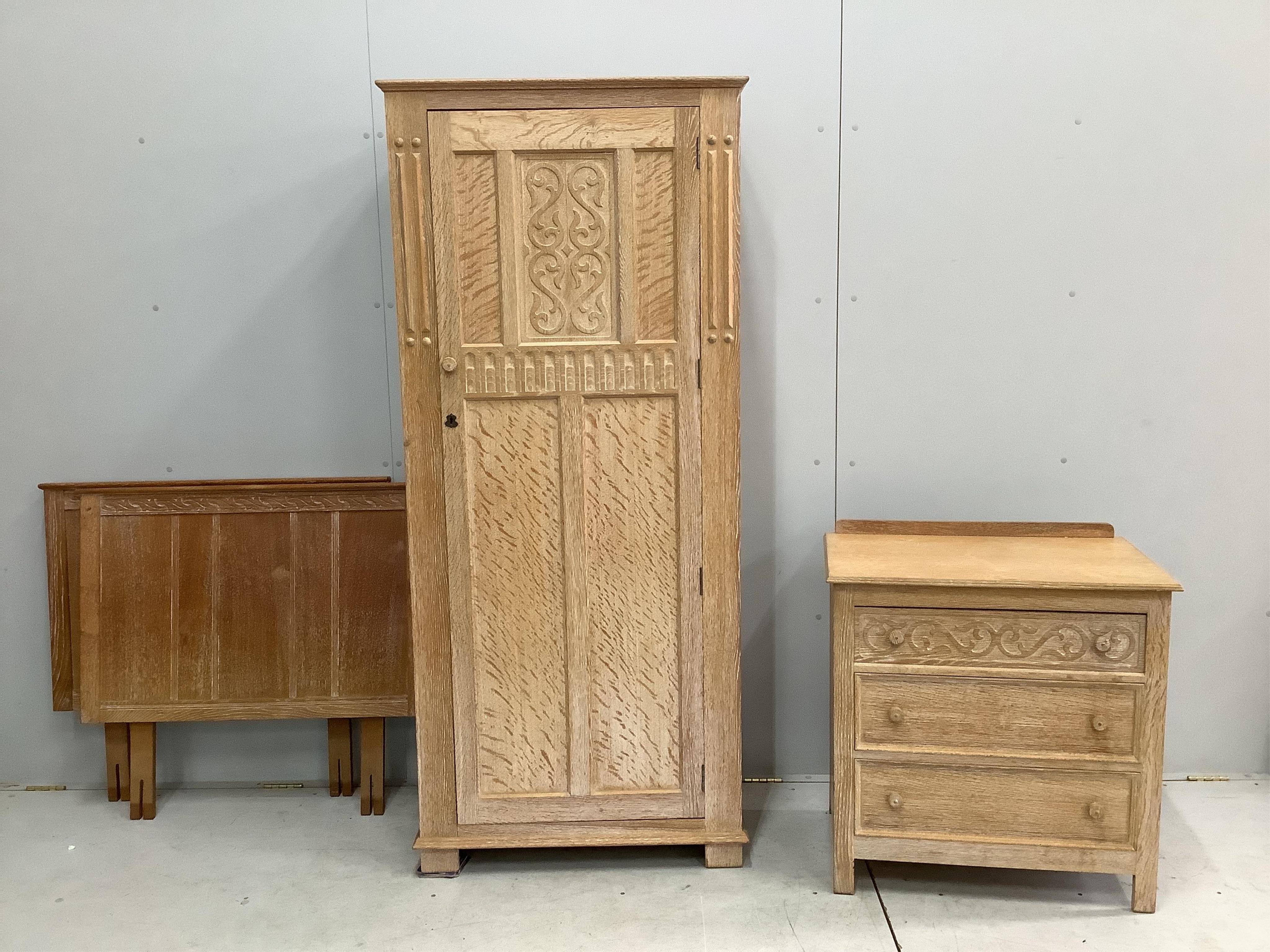 A limed oak four piece bedroom suite, comprising wardrobe, three drawer chest and a pair of single headboards. Condition - good